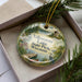 A decorative ornament with a scenic image of Yellowstone Lake State Park, Wisconsin, hanging from a string.