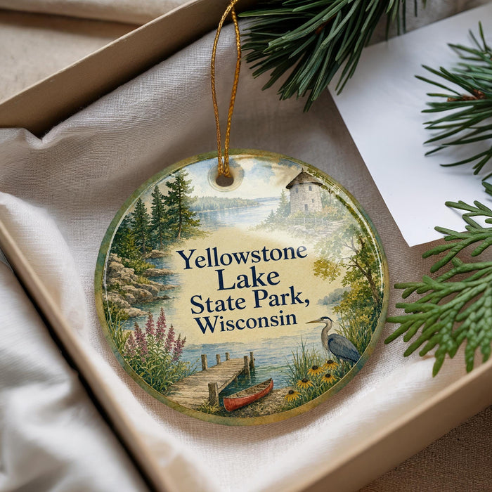 A decorative ornament with a scenic landscape of Yellowstone Lake, State Park, Wisconsin, featuring a dock, a bird, and a house.