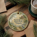 A round ornament with a scenic image of York River State Park, Virginia, hangs on a wooden surface.