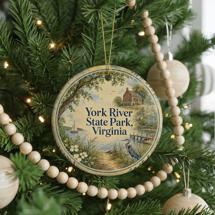 A round ornament hanging on a Christmas tree, featuring a scenic image of York River State Park, Virginia.