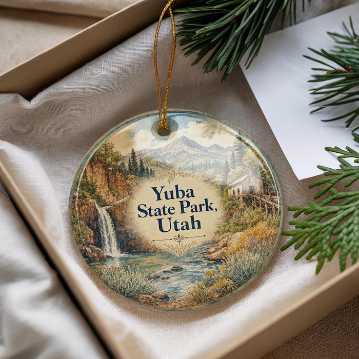 A decorative ornament with a scenic landscape of Yuba State Park, Utah, featuring a waterfall and mountains.