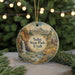 A circular ornament with a scenic landscape of Yucca State Park, Utah, featuring a waterfall and mountains, is displayed against a blurred background of Christmas lights.