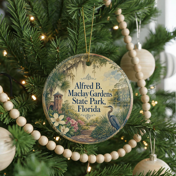 A round ornament hanging on a Christmas tree, featuring a scenic illustration of a park with a bird and a path.