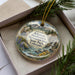 A decorative ornament with a scenic landscape of mountains, water, and wildflowers, featuring the text "Arkansas Headwaters Recreation Area State Park, Colorado" on it.