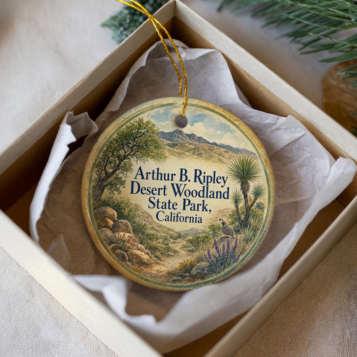 A round ornament with a desert landscape and mountains, featuring the text "Arthur B. Ripley Desert Woodland State Park, California" on it.