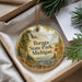 A round ornament with a scenic landscape of Baraga State Park, Michigan, hanging from a string.