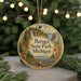 A circular ornament with a scenic landscape of Baraga State Park, Michigan, featuring a waterfall, pine trees, and a lake.