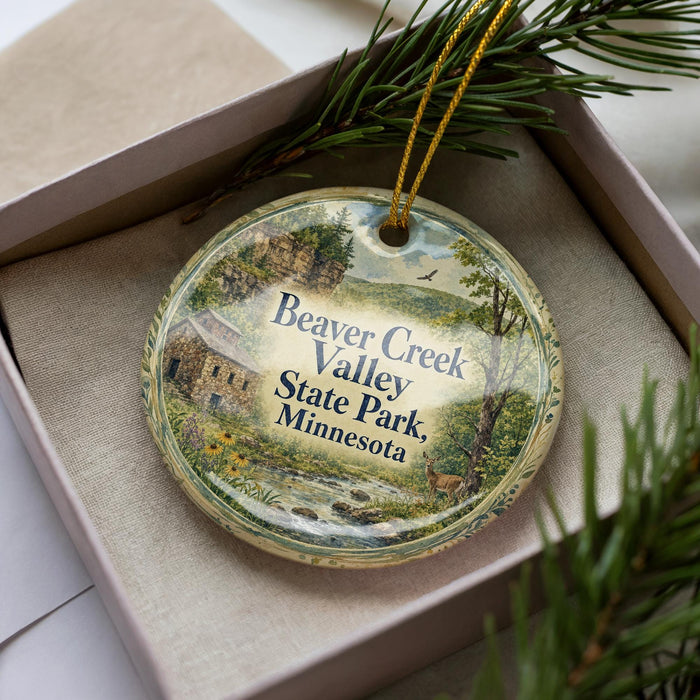 A round ornament with a scenic image of Beaver Creek Valley State Park, Minnesota, hanging from a string.