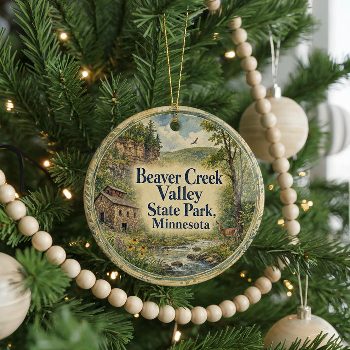 A round ornament hanging on a Christmas tree, featuring a scenic image of Beaver Creek Valley State Park, Minnesota.