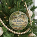 A round ornament hanging on a Christmas tree, featuring an illustration of a historic site in Kentucky.