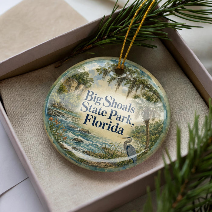 A decorative ornament in a box, featuring a scenic image of Big Shoals State Park in Florida.