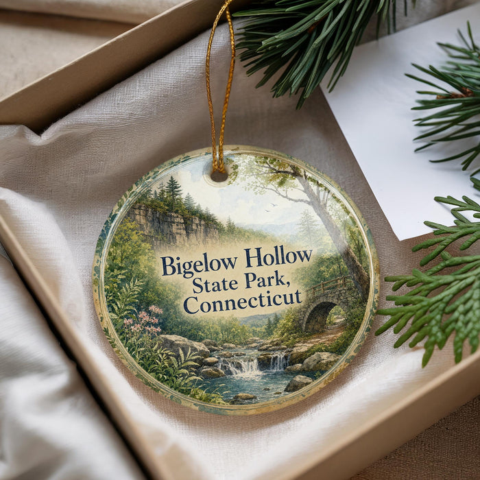 A round ornament with a scenic landscape of Bigelow Hollow State Park, Connecticut, featuring a waterfall and forest.