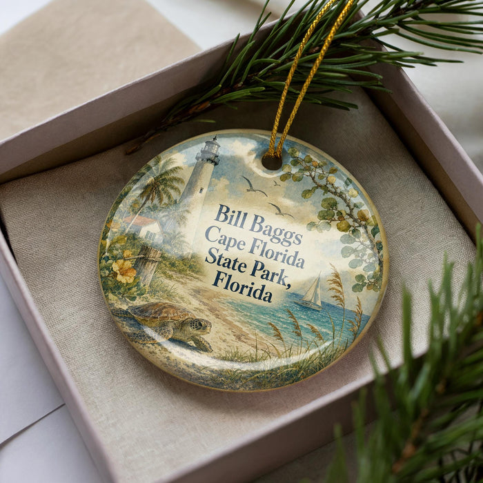 A decorative ornament featuring a lighthouse and beach scene, with the text "Bill Baggs Cape Florida State Park, Florida" printed on it.