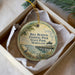 A round ornament in a box, featuring a scenic image of the Bill Burton Fishing Pier in Maryland.