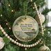 A round ornament hanging on a Christmas tree, featuring a scenic image of the Bill Burton Fishing Pier in Maryland.