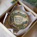 A decorative ornament in a box, featuring a scenic landscape with a waterfall and mountains, along with the text "Black Rock Mountain State Park, Georgia".
