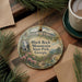 A decorative ornament featuring a scenic image of Black Rock Mountain State Park, Georgia, with pine branches and a cup of coffee nearby.