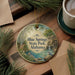 A decorative ornament featuring a scenic image of Blue Springs State Park in Alabama, with a bird perched on a rock in the foreground.