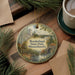 A decorative ornament featuring a scenic landscape of Borderland State Park in Massachusetts, with a castle and a river in the background.