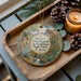 A wooden tray with a decorative ornament featuring a desert landscape, including mountains, cacti, and a small stream. The ornament also includes the text "Boyce Thompson Arboretum State Park, Arizona".