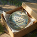 A circular ornament in a wooden box, featuring a scenic image of Bull Shoals-White River State Park in Arkansas.