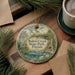A round ornament with a scenic illustration of Bulow Creek State Park, Florida, hanging on a wooden surface.
