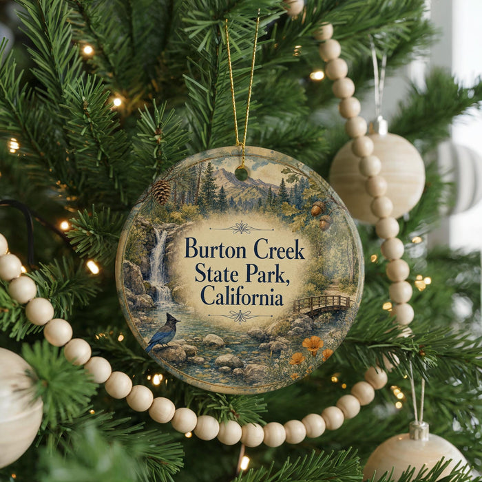 A round ornament hanging on a Christmas tree, featuring a scenic image of a waterfall and pine trees, with the text "Burton Creek State Park, California" displayed prominently.