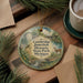 A decorative ornament featuring a scenic image of a deer in a pond, surrounded by a forest and a bridge, with the text "Cambridge Junction Historic State Park, Michigan" displayed on it.