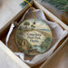 A round ornament with a painting of a beach and palm trees, featuring the text "Camp Helen State Park, Florida" on it.