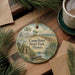 A round ornament with a painting of Camp Helen State Park in Florida, featuring a house, palm trees, and a body of water.