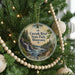 A round ornament hanging on a Christmas tree, featuring a scenic image of the Cascade River State Park in Minnesota.