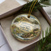 A decorative ornament with a scenic landscape of Castleton Canyon State Park, Colorado, displayed in a box with pine branches.
