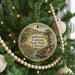 A round ornament hanging on a Christmas tree, featuring a scenic image of Castlewood Canyon State Park, Colorado.