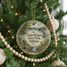 A round ornament hanging on a Christmas tree, featuring a scenic image of Chain O Lakes State Park, Indiana.