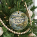 A round ornament hanging on a Christmas tree, featuring a scenic image of Cherry Creek State Park in Colorado.