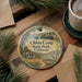A round ornament with a scenic image of China Camp State Park, California, hanging on a wooden surface.