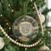 A round ornament hanging on a Christmas tree, featuring an illustration of the Florida Convention Museum and its surrounding landscape.