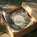 A decorative ornament in a box, featuring an illustration of a historic building and palm trees, with the text "Constitution Convention Museum State Park, Florida" printed on it.