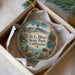 A decorative ornament with a scenic landscape of mountains, water, and pine trees, featuring the text "D. L. Bliss State Park, California".