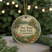 A circular ornament with a scenic landscape of Day Pond State Park, Connecticut, featuring a lake, trees, and a bridge.