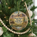 A round ornament hanging on a Christmas tree, featuring a scenic image of Dead Horse Ranch State Park, Arizona.