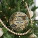 A round ornament hanging on a Christmas tree, featuring illustrations of Delta Heritage Trail State Park in Arkansas.