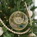 A round ornament hanging on a Christmas tree, featuring a scenic image of Dixon Springs State Park, Illinois.