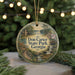 A round ornament with a scenic landscape of Don Carter State Park, Georgia, featuring a river, waterfall, and a cabin, surrounded by pine trees and holiday lights.
