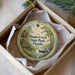 A decorative ornament in a box, featuring a scenic image of Dunns Creek State Park in Florida.
