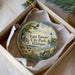 A decorative ornament in a box, featuring a scenic view of East Tawas City Park in Michigan.
