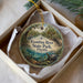 A circular ornament with a scenic image of the Econfina River State Park in Florida, featuring a bird, palm trees, and a bridge.