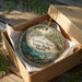 A decorative ornament in a brown box, featuring a scenic image of the Econfina River State Park in Florida.