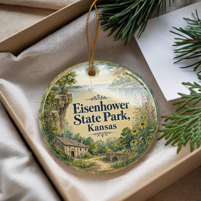 A decorative ornament with a scenic landscape of Eisenhower State Park, Kansas, featuring a house, trees, and a body of water.