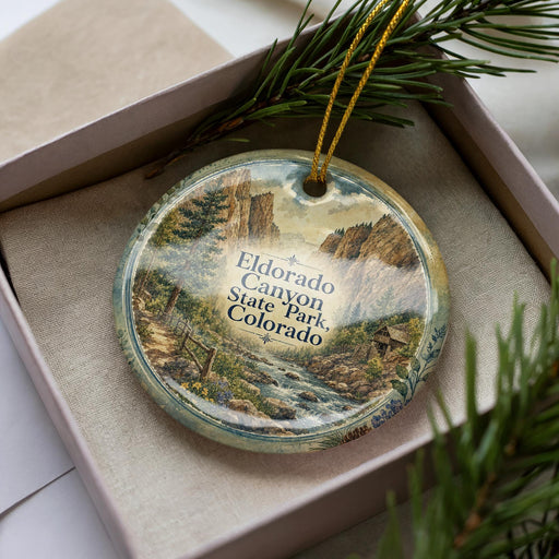 A decorative ornament featuring a scenic landscape of Eldorado Canyon State Park, Colorado, with a river and mountains in the background.